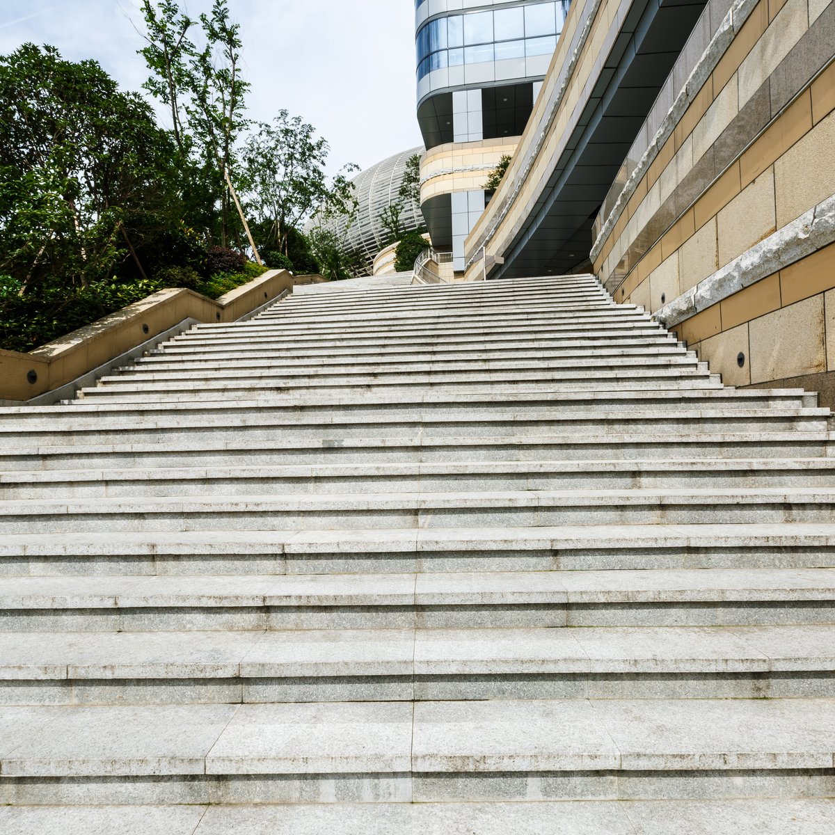 Wide granite masonry staircase climbing to a building entrance - stone steps, porch and stoop repair in Chicago, IL by MasonryPros.us